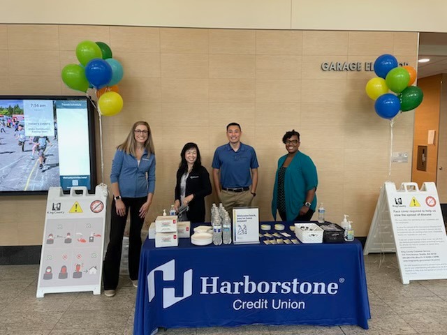 Bank staff posing in front of display
