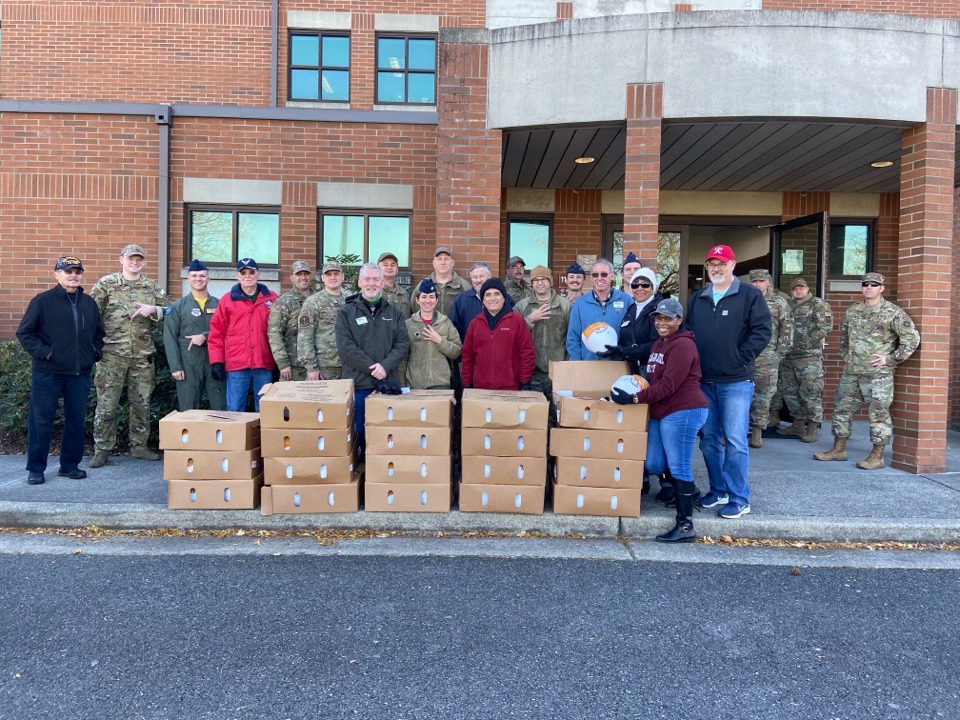 Group of military personal posing with boxes