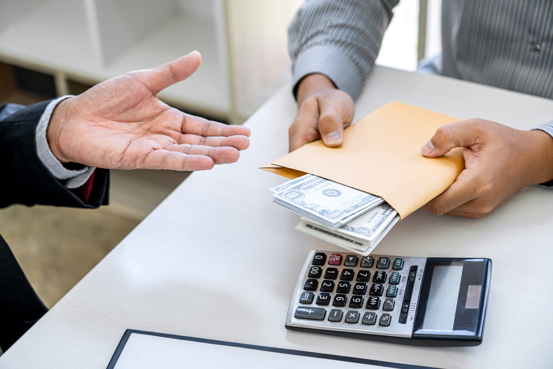 Envelope of money and calculator